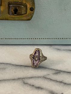 Beautiful 14k white gold antique filigree amethyst ring. There is a small diamond set into the center of the amethyst. Antique Amethyst Ring With Intricate Design, Antique Collectible Amethyst Ring With Center Stone, Antique Amethyst Ring With Filigree, Vintage Amethyst Filigree Jewelry, Vintage Multi-stone Amethyst Ring In 14k Gold, Antique Filigree, Etsy Gold Ring, Purple Band, 14k White Gold Ring