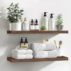 two shelves with towels, soaps and other bathroom items on them next to a potted plant