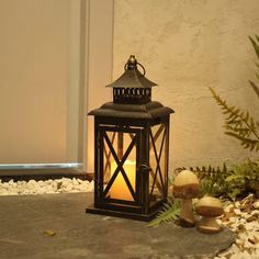 a lit lantern sitting on top of a stone floor