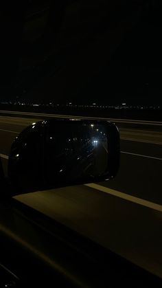 a car's rear view mirror is shown at night