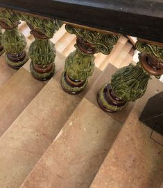 a set of stairs with green vases on them