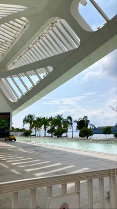 the inside of a building with water and palm trees in the background on a sunny day