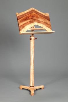 a wooden easel with an open top on a metal stand against a gray background