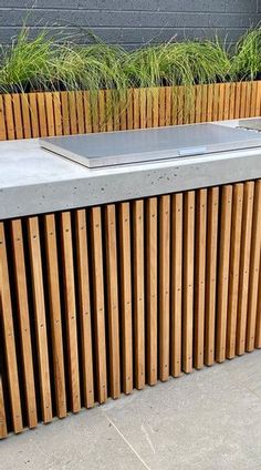 an outdoor bar made out of wooden slats and metal bars on the side of a building