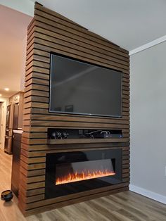 a television mounted on top of a wall next to a fire place in a living room