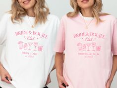 two women standing next to each other wearing matching shirts