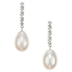 Tear drop freshwater cultured pearl and diamond dangle drop earrings. Wedding style, Two pear shaped, 10.5mm-14.7mm Pearls accented with 8 round cut diamonds in 14k white gold. 16 round diamonds, H-I SI approx. .32cts 2 freshwater white pearl drops, 10.5mm -14.7mm 14k white gold Stamped: 14k 6.5 grams Top to bottom: 33.5mm or 1.38 Inches Width: 10.4mm or .4 Inches Depth or thickness: 10.5mm Elegant Pear-shaped Diamond Earrings For Evening, Briolette Diamond Accent Earrings For Formal Occasions, Formal Briolette Earrings With Diamond Accents, Formal Briolette Diamond Accented Earrings, Formal Pear Shaped Diamond Pearl Earrings, Formal Pear-shaped Diamond Pearl Earrings, Elegant Briolette Diamond Earrings For Formal Occasions, Luxury Drop Pearl Earrings For Formal Occasions, Luxury Drop Pearl Earrings For Formal Events