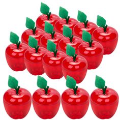 a group of red apples with green leaves on them