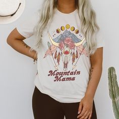 "Designed and handmade in Phoenix. Take me to the mountains! This boho free-spirited mountain theme tee is perfection! ★ABOUT OUR UNISEX TEES★ Our unisex tees are super soft, long and lean. Customers consistently mention the tees run large, so order down for a tighter fit. Our cream tees are 100% cotton; our white and certain colors are a super soft triblend that is thinner than our 100% cotton tees. If 100% cotton is something you prefer, the cream tees are the way to go. If you have any questi Bohemian Relaxed Fit T-shirt With Letter Print, Bohemian Printed T-shirt For Festivals, Free-spirited Short Sleeve Tops For Festival, Bohemian Relaxed Fit T-shirt For Festival, Free-spirited Relaxed Fit Tops For Festival, Hippie Graphic Print Festival Tops, Hippie Style Printed T-shirt For Festivals, Bohemian Graphic Print Tops For Music Festival, Bohemian Tops With Screen Print, Relaxed Fit