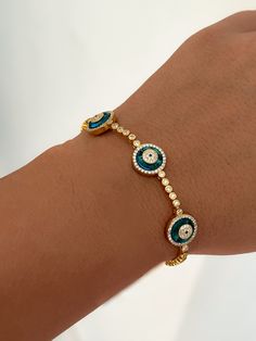 Elevate your style with our exquisite 14k Gold Evil Eye Bracelets, designed for protection and good fortune. Crafted with precision, our Evil Eye Jewelry collection features intricate details and quality materials. Stand out with our Clear Blue Nazar Protection Bracelet, a symbol of serenity and strength. Perfect for everyday wear or special occasions, shop now and add a touch of elegance to your outfit.    Explore our stunning Moissanite Tennis Bracelet selection, featuring the perfect blend of sophistication and sparkle. Indulge in luxury with our Diamond Moissanite Bracelets, handcrafted to perfection. Embrace timeless beauty and elegance with our eye-catching designs that effortlessly elevate your look. Each piece is meticulously crafted to enhance your style and make a statement. Disc Nazar Jewelry, Elegant Metal Evil Eye Bracelet, Elegant Gold-plated Evil Eye Bracelet Gift, Bracelets Evil Eye, Cheap Gold Hand-strung Evil Eye Bracelet, Adjustable Blue Evil Eye Bracelet Hand-strung, Affordable Adjustable Hand-strung Evil Eye Bracelet, Eye Bracelets, Bracelet Diamond