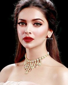 an image of a woman with red lipstick and jewelry on her face, looking at the camera