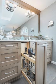 an open cabinet in a kitchen with lots of clutter on the counter and drawers