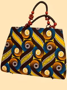 Made from 100% African wax cotton  Featuring zip closure  wooden beaded handle  inside pocket  lined Measures approx hxlxw. 28x38x17cm Handmade Brown Fabric Bags, Brown Cotton Rectangular Satchel, Brown Bag With Wooden Beads For Everyday Use, Boys Clothing, Waxed Cotton, Coach Dinky Crossbody, Hand Bag, African Print, Ankara