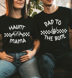 two people sitting on a couch wearing t - shirts that say,'haunt to mama the bone '