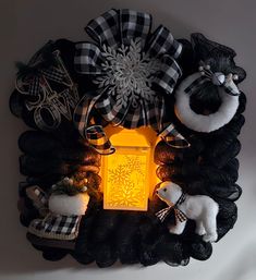 a lighted lantern surrounded by black and white decorations