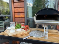 an outdoor grill with vegetables and meat on it