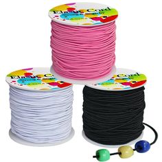 three spools of black, white and pink cord