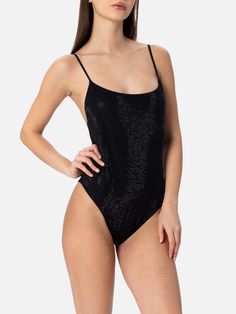 Keep it classic with Cecille's delicate straps and scooped neckline that perfectly combine comfort and elegance. This one-piece swimsuit is crafted from lurex fabric, woven with fine metallic threads for a unique shimmering finishOne-piece swimsuitThin strapsScoop backClassic bottom coverageBlack plain color with black rhinestonesComposition: 64% viscose 17% polyester 15% polyamide 4% elastaneLining: 90% polyamide 10% elastane Party Swimwear With Adjustable Straps And Backless Design, Party Backless Swimwear With Adjustable Straps, Luxury Fitted Swimwear For Summer, Luxury Fitted Swimwear For Swimming, Elegant Evening Nylon Bodysuit, Fitted Low Back Bodysuit For Party, Elegant Evening Bodysuit, Summer Evening Polyamide Bodysuit, Evening Backless Lined Swimwear