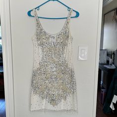 This Dress Is In Excellent Condition! Only Worn Twice! Fitted And Super Comfortable! It Is A Size 4. It Has A Sheer Overlay Accented With Silver Sequins And Cream Embroidery. This Dress Is A Show Stopper! Double Scoop Neckline. Hidden Back Zip Closure. White Sleeveless Embellished Mini Dress, White Embellished Dress For Night Out, White Sequin Mini Dress For Cocktail, White Embellished Sleeveless Dress, White Mini Evening Dress For Summer, White Mini Dress For Summer Evening, White Mini Dress For Party Season, Cream Embroidery, Sheer Overlay