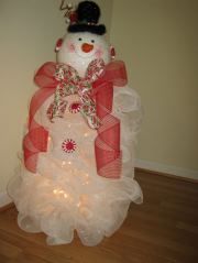 a snowman made out of tulle with lights on it's head and legs