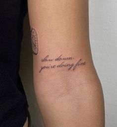 a woman with a tattoo on her arm that says, you are doing fine