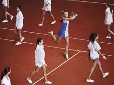 a group of women standing on top of a tennis court