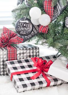 presents under the christmas tree are wrapped in black and white checkered paper with red bows