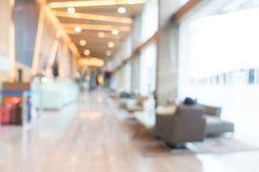 blurry photo of an airport lobby with couches and chairs