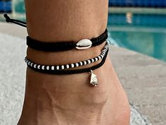 A combination of three handmade anklets curated for ocean lovers in black&white colors. Set includes 1 braided bracelet, 1 square knotted bracelet with a natural shell, and 1 beaded bracelet. Anklet size 8.5" can be adjusted approx. to 10.5"  Please note: Colours may look different depending on your monitor. Thank you for supporting me as an artist. I put my creativity and love into every product I make. When you buy handmade, you are buying much more than a thing; you are buying hours of experimentation and days of work; you are buying a piece of the human heart. Follow me for more photos and styles https://instagram.com/stasy_design Casual Black Braided Bracelets For Beach, Handmade Black Braided Bracelets For Beach, Black Friendship Bracelets For Summer Beach, Black Friendship Bracelets For Beach In Summer, Black Friendship Bracelets For Beach And Summer, Black Bracelet With Sliding Knot For Beach, Summer Beach Black Friendship Bracelets, Black Adjustable Anklets For The Beach, Black Adjustable Anklets For Beach