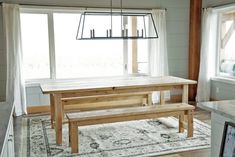 a wooden table and bench in a room