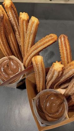 several churros with dipping sauce in small bowls