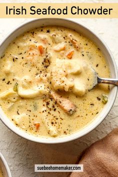 a bowl of soup with chicken and dumplings in it on a white table next to a spoon