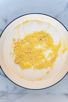 a white plate topped with food on top of a marble counter