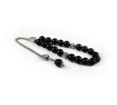 Handcrafted Greek Komboloi - Worry Beads created from silver tone metal chain of 20 black onyx Beads, 2 metal round beads and triangle shape metal Master Bead. A pocket sized set of greek worry beads which can be used for passing time and relaxation. It would also make a beautiful gift. Features: Item Length: 23cm / 9 inches Beads Size: 10mm / 0.40 inches Beads Material: Black onyx beads Metal Materials: Silver tone alloy Here you can browse more items in our shop: https://www.etsy.com/shop/sunn Black Beaded Chain Beads As Gift, Black Beaded Chain As A Gift, Black Beaded Chain For Gift, Onyx Black Beads For Gifts, Elegant Adjustable Silver Beads Rosary, Elegant Adjustable Rosary With Silver Beads, Silver Rosary With Black Beads As Gift, Silver Beads, Gems, And Cabochons For Gifts, Silver Beads Gems And Cabochons For Gifts