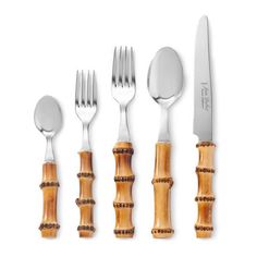 an assortment of silverware with bamboo handles