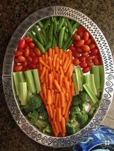 a bowl filled with carrots, celery and broccoli on top of a table