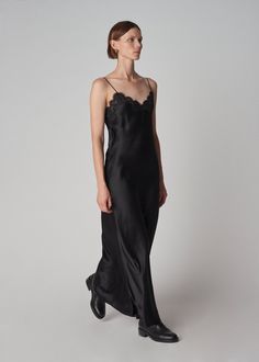 Long slip dress in 16mm opaque biascut silk satin glides gracefully against the skin. French lace trims the neckline. Adjustable spaghetti straps and cleverly positioned encased elasticized back ensure proper fit. French seam, baby hem. Details 100% Silk Trim: 50% Cotton 30% Viscose 20% Polyamide 4704CSSC-CORE Black True to size. See size guide. Approx 47" in total length. Model is 5'9" 30" bust and wears a size Small. Black Velvet Slip Dress, Velvet Slip Dress, Long Slip Dress, Long Slip, Black Slip Dress, Lace Slip Dress, Lace Camisole, Lace Trims, French Seam