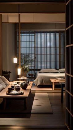 a living room filled with lots of furniture next to a bed and table in front of a window