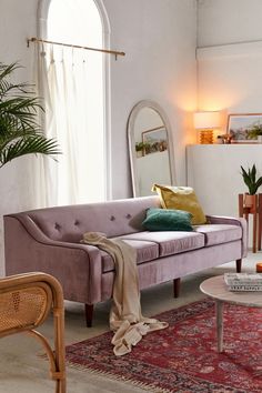 a living room filled with furniture and a large mirror on the wall above it's headboard