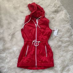 Brand New With Tags Tommy Hilfiger Rain Jacket Vest In Red. Never Worn. Also Comes With A Bag For The Jacket. Red Sleeveless Outerwear For Fall, Red Sleeveless Fall Outerwear, Tommy Hilfiger Casual Spring Outerwear, Casual Tommy Hilfiger Outerwear For Spring, Red Nylon Outerwear For Spring, Red Hooded Outerwear For Spring, Red Fitted Nylon Outerwear, Trendy Red Windbreaker For Fall, Red Nylon Windbreaker For Spring