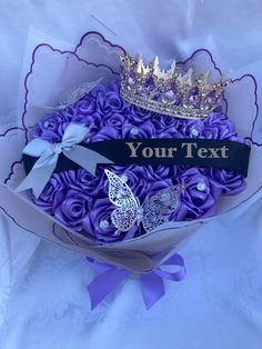 purple roses in a bouquet with a tiara on top that says, your text