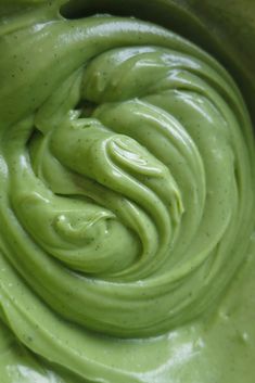 a bowl filled with green liquid on top of a table