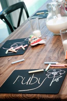 a wooden table with chalk writing on it