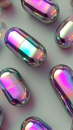 many different colored pill shaped objects on a gray surface with white and blue lights in the middle