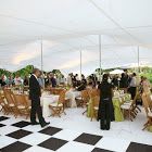 a group of people that are standing around tables