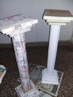 two white pedestals sitting on top of each other in front of a pile of money