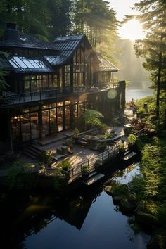 the house is surrounded by trees and has a dock on one side that leads to it