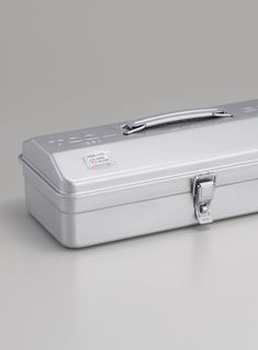 a silver suitcase sitting on top of a white table