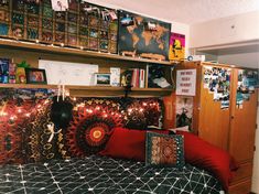 a bed room with a neatly made bed and lots of pictures on the wall above it