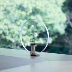 a vase with flowers in it sitting on a table next to a window sill